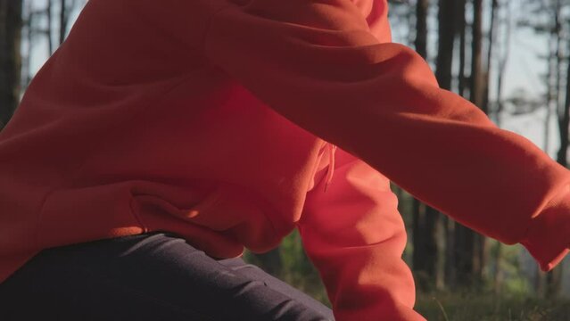 A female runner is massaging her cramping legs while running. Athletes injured during exercise. Health and sports concept.