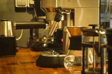 Expresso machine on wooden table. suitable for coffee shop wallpaper.