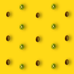 Colorful fruit pattern of fresh kiwi slices on yellow background. Top view. Flat lay. Pop art design
