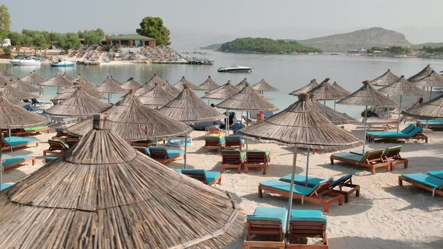 Beautiful beach with umbrellas and sunbeds in Ksamil, Albania 
