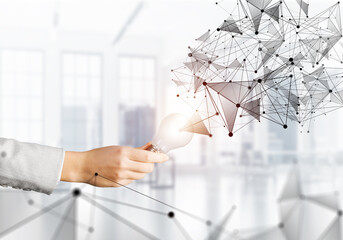 Human hand with glowing lamp and abstract network