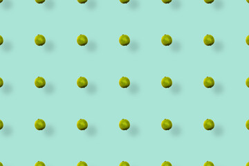 Colorful fruit pattern of fresh limes on green background with shadows. Top view. Flat lay. Pop art design