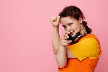 cheerful woman grimace headphones entertainment emotions music pink background unaltered