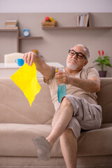 Old man doing housework at home