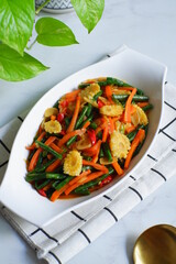 a plate of vegetables stir fry against white background 