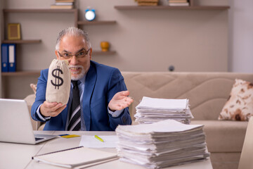 Fototapeta premium Old male boss working from home in remuneration concept