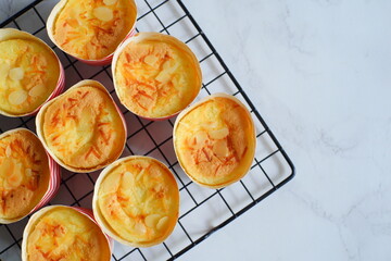 cake topped with cheese grated in a cup against white background 