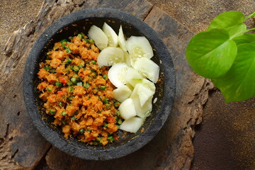 a plate of  traditional food named sambal urap  that made from fresh coconut grated with ground raw spices 