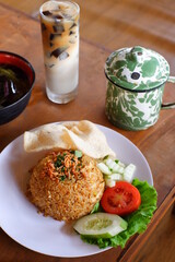 a plate of seafood fried rice with vegetables 