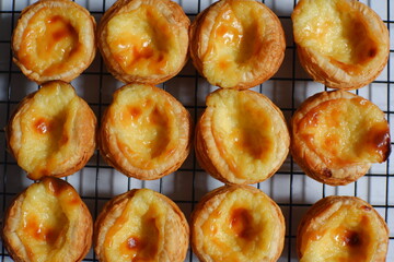 pile of egg tarts against white background 