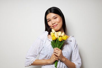 woman in a white shirt flowers spring posing light background unaltered