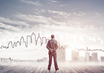 Motivation and inspiration concept with modern cityscape and businessman observing it