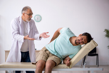 Young male patient visiting old male doctor