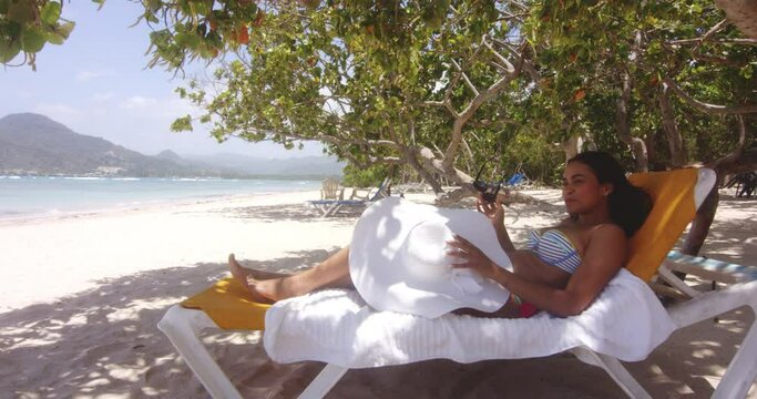 Latino Dominican Lady Gets Up from Sun Lounger on Tropical Beach Resort Playa Teco Maimon