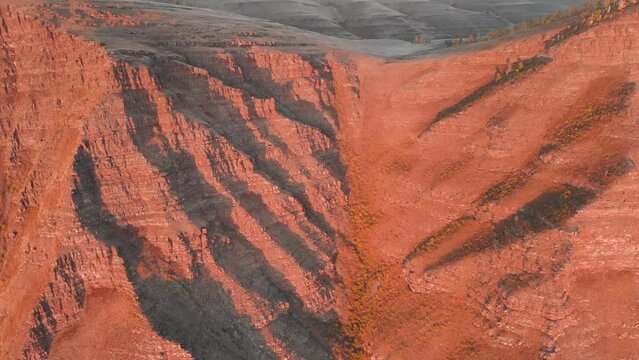 Flying over rugged rocks in the rays of the setting sun, a view from a height on the details of rocks, gorges and hollows. Tepsey Khakassia