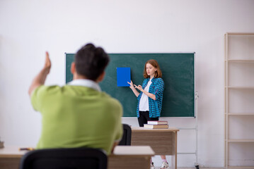 Fototapeta premium Young teacher and student in the classroom