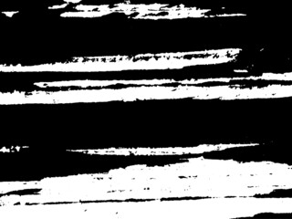 Grunge is black and white. Texture of black strokes on a white background. Abstract chaotic movements with a dry brush. Monochrome pattern of worn surface