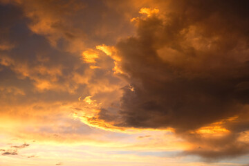 Beautiful sunset with golden orange clouds  background. Dramatic background.