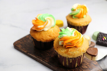 Tiranga Cupcake or Tricolor Cupcake with Indian National Flag colors frosting. saffron or orange, white and green. The concept for Indian happy Independence or Republic day greeting card. copy space.