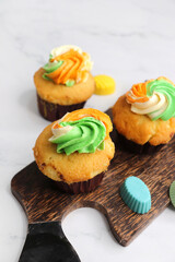 Tiranga Cupcake or Tricolor Cupcake with Indian National Flag colors frosting. saffron or orange, white and green. The concept for Indian happy Independence or Republic day greeting card. copy space.