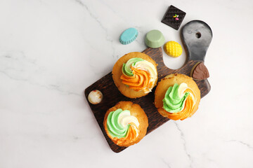 Tiranga Cupcake or Tricolor Cupcake with Indian National Flag colors frosting. saffron or orange, white and green. The concept for Indian happy Independence or Republic day greeting card. copy space.