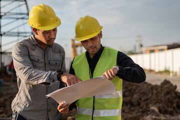 Engineers men working on building site. Construction manager and engineer meeting and discussion about project in construction site.