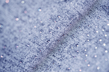 knitted blue fabric with rhinestones. soft focus