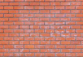 Salt on the red brick wall of the house as a background.
