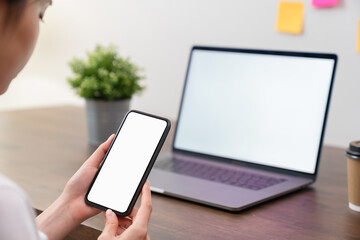 Woman hand holding smartphone and touching blank screen. Mockup of advertisement.