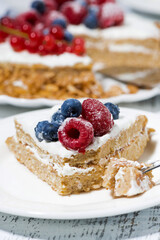 piece of healthy oatmeal cake with yogurt and fresh berries, vertical closeup