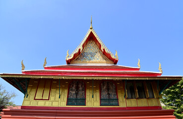 Part of the Roof of a temple in Thailand. Traditional Thai style pattern on the roof of a temple with Blue Sky Background.