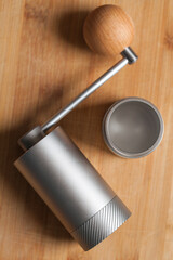 Open manual coffee grinder made of shiny metal alloy