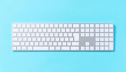 Computer keyboard on light blue background. 水色背景上のパソコンのキーボード