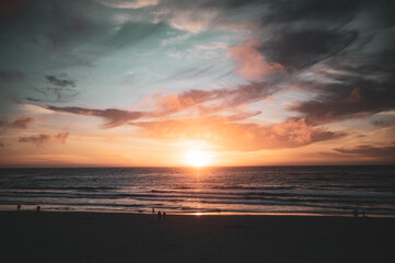 Fototapeta na wymiar Last light of the day flares at Carmel Beach, Carmel-By-The-Sea, California