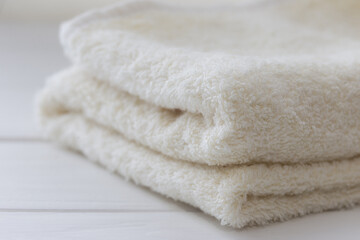 Obraz na płótnie Canvas White fluffy bath towels on the white background 