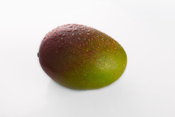 juicy delicious mango with water drops on a white background