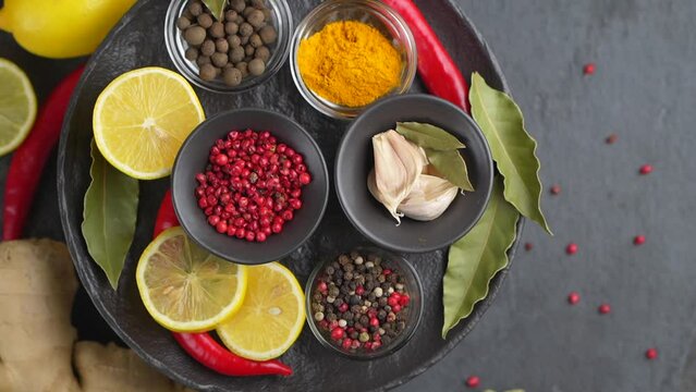 Colourful background from various herbs and spices for cooking in bowls. Top view