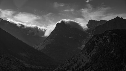 Cloud covering a mountain in Glacier National park on Going to the Sun road