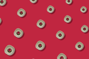 Colorful pattern of rolls of a white toilet paper isolated on red background. Top view. Wallpaper for bathroom