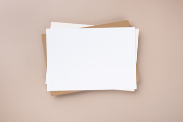 Minimal paper card mockup on beige background. Flat lay, top view