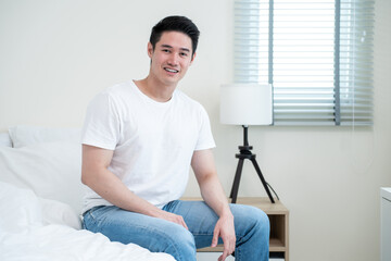 Portrait of Asian handsome male in pajamas smile and looking at camera