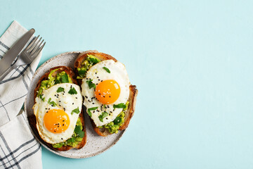 Healthy breakfast with eggs toast and orange juice on blue background