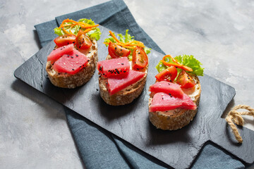 Tuna Carpaccio. Classic Japanese or American restaurant appetizer. Raw tuna thinly sliced and served spicy Mustard and Asian-inspired sauces