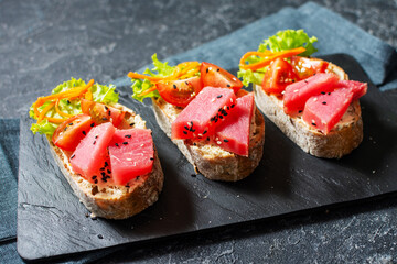 Tuna Carpaccio. Classic Japanese or American restaurant appetizer. Raw tuna thinly sliced and served spicy Mustard and Asian-inspired sauces