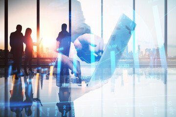 Abstract image of businessman using laptop in modern office interior with glowing forex graph,...