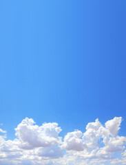 Vertical nature background with white clouds in the blue sky