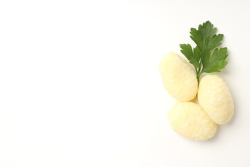 Raw potato gnocchi on white background, space for text