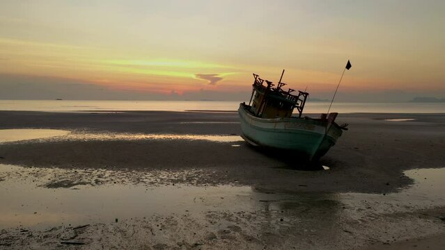 Sunset scenes of boat wreck along shore side - Drome passing ship hull towards the ocean - Nathon harbour - Koh Samu Island in Thailand