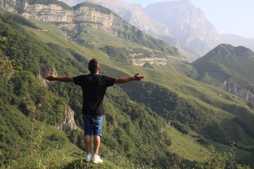 Traveler hiking in mountains clouds landscape