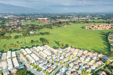 Fototapeta premium Land and housing estate in aerial view. May call residential building, village, community. Real estate or property from subdivision, construction, development for sale, buy and mortgage in Chiang Mai.